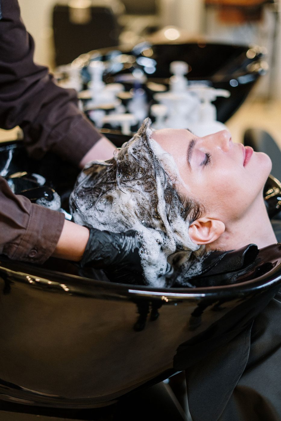 Licensed stock photograph: hair being washed at a salon basin.